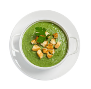 Cream soup with dried crusts isolated on white, studio shot